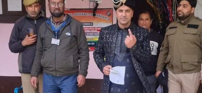 Groom votes in wedding attire in Ganderal’s Kangan